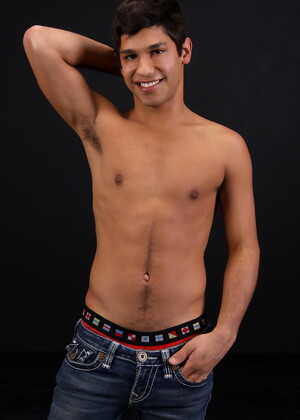 Carmine posing naked in a bedroom